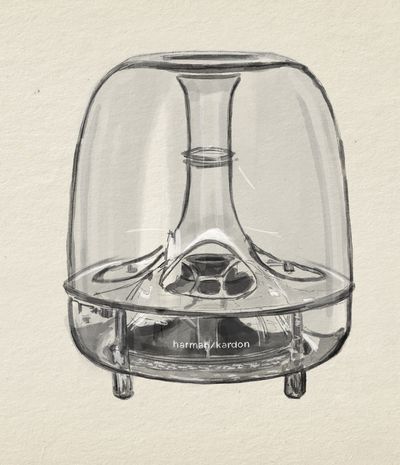 The subwoofer alone: a clear polycarbonate dome over a six-inch downward-firing cone, the porting and internal structure left wholly on view. The cnidarian aspect that earned the genus its name is most legible here. The rotary collar at its base is the only mechanical control on the system, and the mains switch is built into it.